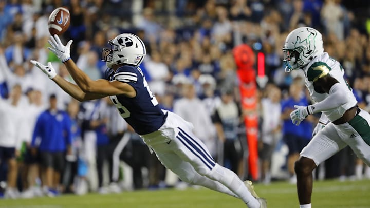 Sep 25, 2021; Provo, Utah, USA; Brigham Young Cougars wide receiver Gunner Romney (18) makes a reception for a first down past South Florida Bulls defensive back TJ Robinson (2) in the first quarter at LaVell Edwards Stadium. Mandatory Credit: Jeffrey Swinger-Imagn Images Sep 25, 2021; Provo, Utah, USA; Brigham Young Cougars wide receiver Gunner Romney (18) makes a reception for a first down past South Florida Bulls defensive back TJ Robinson (2) in the first quarter at LaVell Edwards Stadium. Mandatory Credit: Jeffrey Swinger-Imagn Images