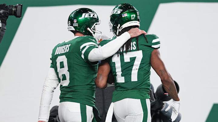 Jan 5, 2025; East Rutherford, New Jersey, USA; New York Jets quarterback Aaron Rodgers (8) and wide receiver Davante Adams (17) celebrate after a touchdown during the second half against the Miami Dolphins at MetLife Stadium. Mandatory Credit: Vincent Carchietta-Imagn Images