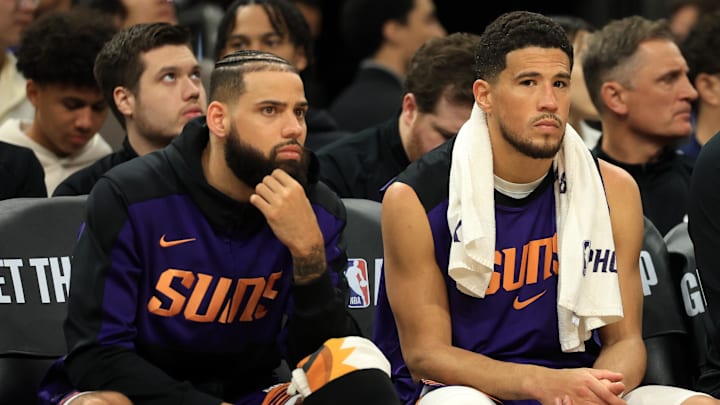 Apr 8, 2025; Phoenix, Arizona, USA; Phoenix Suns guard Devin Booker (1) sits on the bench during the second half against the Golden State Warriors at Footprint Center. Mandatory Credit: Mark J. Rebilas-Imagn Images