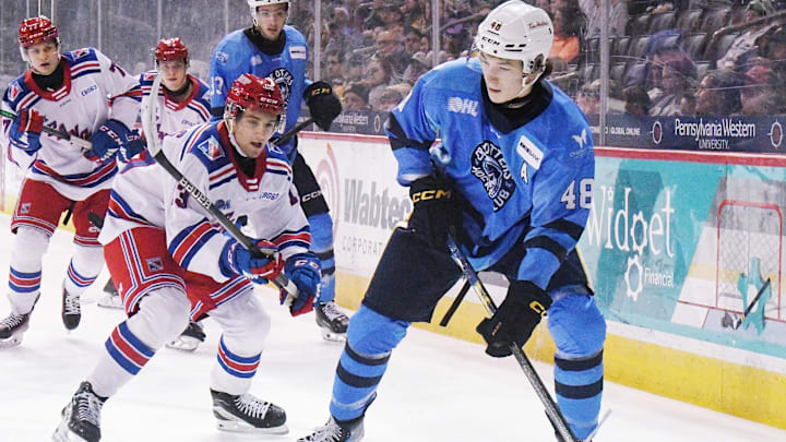 Erie Otters defenseman Matthew Schaefer, right, controls the puck against the Kitchener Rangers at Erie Insurance Arena in Erie on Nov. 23, 2024.