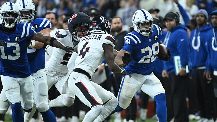 Nov 30, 2025; Indianapolis, Indiana, USA; Indianapolis Colts running back Jonathan Taylor (28) runs against Houston Texans cornerback Kamari Lassiter (4) during the first half at Lucas Oil Stadium. Mandatory Credit: Robert Goddin-Imagn Images Nov 30, 2025; Indianapolis, Indiana, USA; Indianapolis Colts running back Jonathan Taylor (28) runs against Houston Texans cornerback Kamari Lassiter (4) during the first half at Lucas Oil Stadium. Mandatory Credit: Robert Goddin-Imagn Images