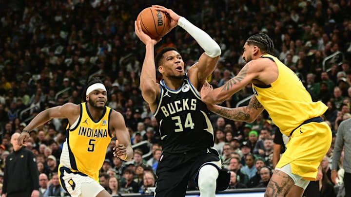 Apr 27, 2025; Milwaukee, Wisconsin, USA: Milwaukee Bucks forward Giannis Antetokounmpo (34) takes a shot against Indiana Pacers forward Obi Toppin (1) and forward Jarace Walker (5) in the third quarter during game four of first round for the 2024 NBA Playoffs at Fiserv Forum. Mandatory Credit: Benny Sieu-Imagn Images