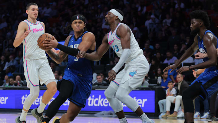 Orlando Magic forward Paolo Banchero (5) drives to the basket against Miami Heat center Bam Adebayo (13) during the fourth quarter at Kaseya Center.