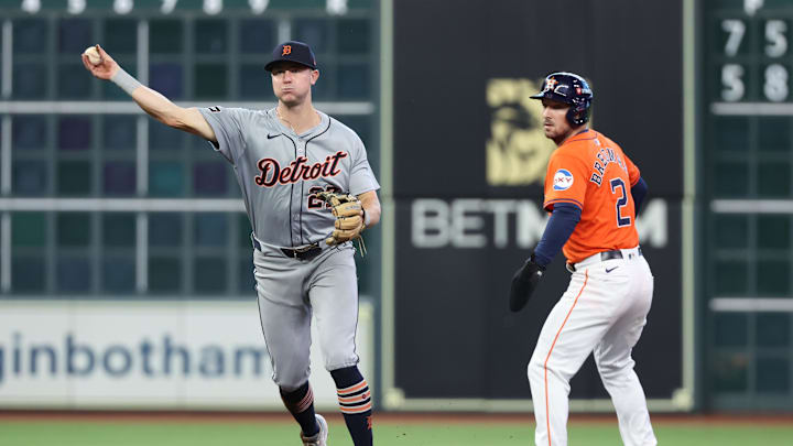 Oct 2, 2024; Houston, Texas, USA; Detroit Tigers shortstop Trey Sweeney (27) throws to first base to retire Houston Astros catcher Victor Caratini (not pictured) as Houston third baseman Alex Bregman (2) advances to second during the second inning of game two of the Wildcard round for the 2024 MLB Playoffs at Minute Maid Park. 