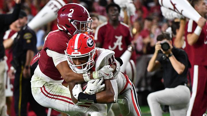 Sep 28, 2024; Tuscaloosa, Alabama, USA; Georgia Bulldogs wide receiver Arian Smith (11) is tackled by Alabama Crimson Tide defensive back Zabien Brown (2) after a long reception to set up a touchdown at Bryant-Denny Stadium. Alabama defeated Georgia 41-34. Sep 28, 2024; Tuscaloosa, Alabama, USA; Georgia Bulldogs wide receiver Arian Smith (11) is tackled by Alabama Crimson Tide defensive back Zabien Brown (2) after a long reception to set up a touchdown at Bryant-Denny Stadium. Alabama defeated Georgia 41-34.