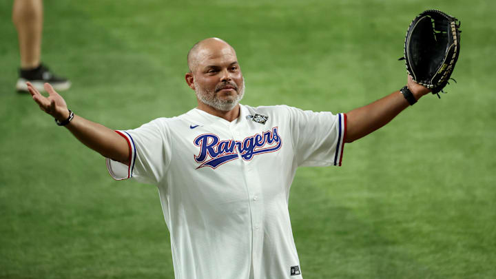Oct 27, 2023; Arlington, TX, USA; Former Rangers player and Hall of Famer Ivan Rodriguez catches the ceremonial first pitch before game one of the 2023 World Series between the Arizona Diamondbacks and Texas Rangers at Globe Life Field. 
