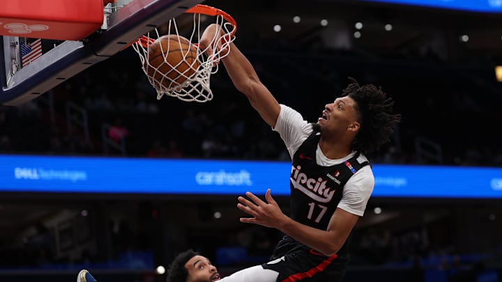 Portland Trail Blazers guard Sharpe dunks the ball over Washington Wizards forward Champagnie in the first half at Capital One Arena.
