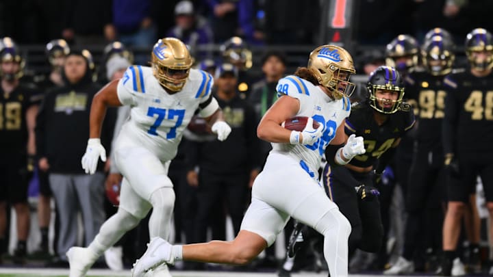 Nov 15, 2024; Seattle, Washington, USA; UCLA Bruins tight end Moliki Matavao (88) carries the ball after making a catch against the Washington Huskies during the first half at Alaska Airlines Field at Husky Stadium. Mandatory Credit: Steven Bisig-Imagn Images