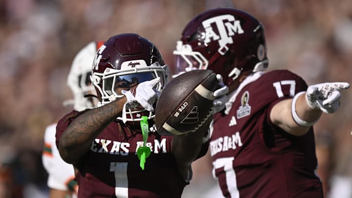 Texas A&M Aggies wide receiver Mario Craver and tight end Theo Melin Öhrström celebrate a first down against the Miami Hurricanes during the second half of the first round game of the CFP National Playoff at Kyle Field. 
