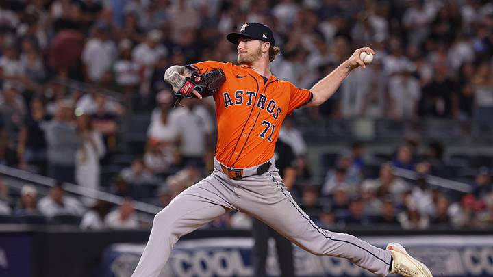 Josh Hader throws a baseball in an orange Astros jerse