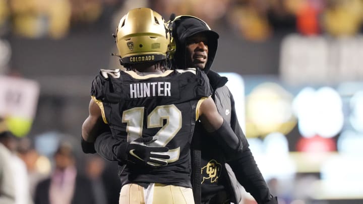 Oct 13, 2023; Boulder, Colorado, USA; Colorado Buffaloes wide receiver Travis Hunter (12) is congratulated for his touchdown by head coach Deion Sanders in the first quarter against the Stanford Cardinal at Folsom Field. Mandatory Credit: Ron Chenoy-USA TODAY Sports Oct 13, 2023; Boulder, Colorado, USA; Colorado Buffaloes wide receiver Travis Hunter (12) is congratulated for his touchdown by head coach Deion Sanders in the first quarter against the Stanford Cardinal at Folsom Field. Mandatory Credit: Ron Chenoy-USA TODAY Sports