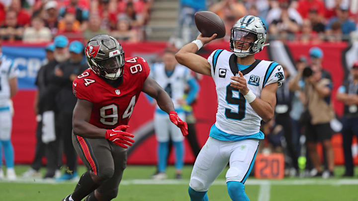 Dec 29, 2024; Tampa, Florida, USA; Carolina Panthers quarterback Bryce Young (9) throws the ball as Tampa Bay Buccaneers defensive tackle Calijah Kancey (94) rushes during the second quarter at Raymond James Stadium. Mandatory Credit: Kim Klement Neitzel-Imagn Images