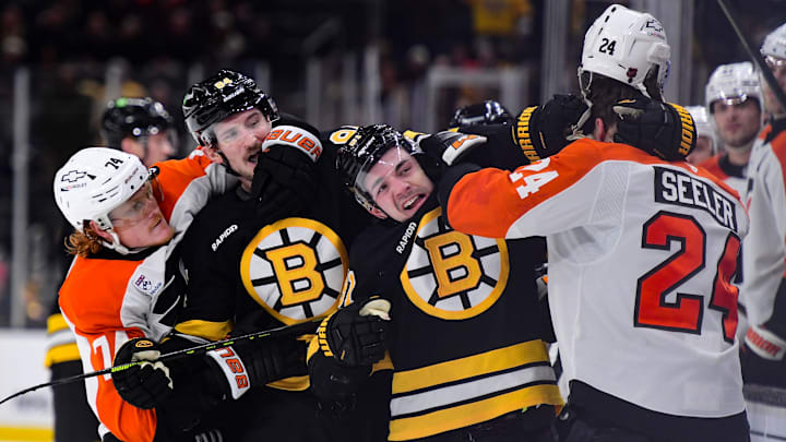 Jan 29, 2026; Boston, Massachusetts, USA; Philadelphia Flyers right wing Owen Tippett (74) Boston Bruins left wing Tanner Jeannot (84) center Michael Eyssimont (81) and defenseman Nick Seeler (24) grapple during the third period at TD Garden. Mandatory Credit: Bob DeChiara-Imagn Images