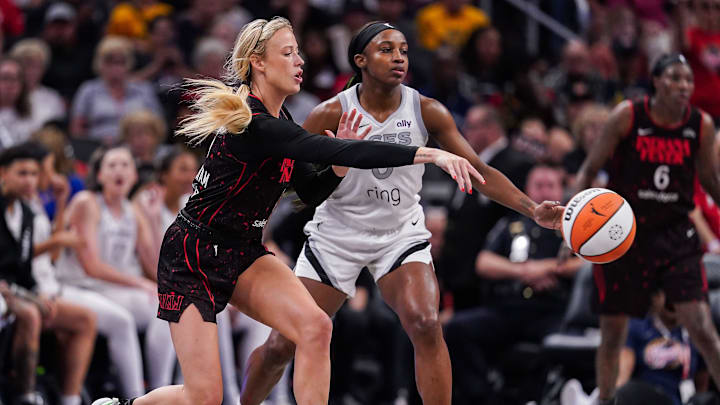Indiana Fever guard Sophie Cunningham (8) passes the ball against Las Vegas Aces guard Jackie Young (0) on Thursday, July 24, 2025, during the game at Gainbridge Fieldhouse in Indianapolis.