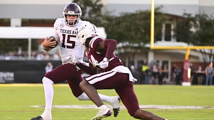 Oct 19, 2024; Starkville, Mississippi, USA;  Texas A&M Aggies quarterback Conner Weigman (15) runs the ball against Mississippi State Bulldogs cornerback Brice Pollock (14) during the third quarter at Davis Wade Stadium at Scott Field. Mandatory Credit: Matt Bush-Imagn Images