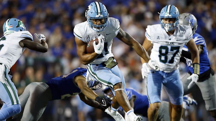 Oct 13, 2023; Memphis, Tennessee, USA; Tulane Green Wave running back Makhi Hughes (21) runs the ball during the second half against the Memphis Tigers at Simmons Bank Liberty Stadium. Mandatory Credit: Petre Thomas-Imagn Images