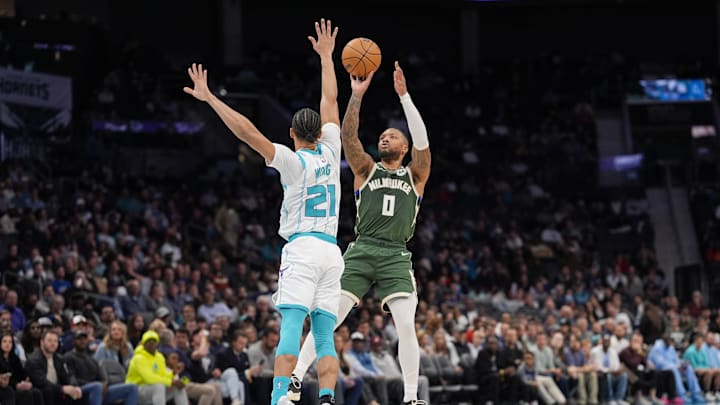 Feb 5, 2025; Charlotte, North Carolina, USA; Milwaukee Bucks guard Damian Lillard (0) shoots the jumper over Charlotte Hornets guard KJ Simpson (25) during the second quarter at Spectrum Center. Mandatory Credit: Jim Dedmon-Imagn Images Feb 5, 2025; Charlotte, North Carolina, USA; Milwaukee Bucks guard Damian Lillard (0) shoots the jumper over Charlotte Hornets guard KJ Simpson (25) during the second quarter at Spectrum Center. Mandatory Credit: Jim Dedmon-Imagn Images