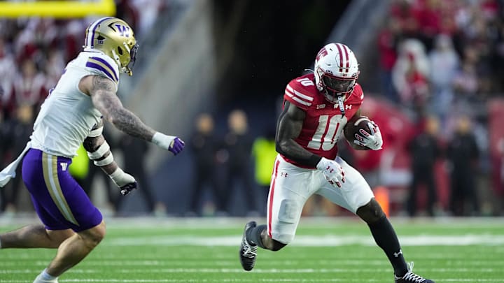 Nov 8, 2025; Madison, Wisconsin, USA;  Wisconsin Badgers running back Gideon Ituka (10) rushes with the football during the first quarter against the Washington Huskies at Camp Randall Stadium. Mandatory Credit: Jeff Hanisch-Imagn Images