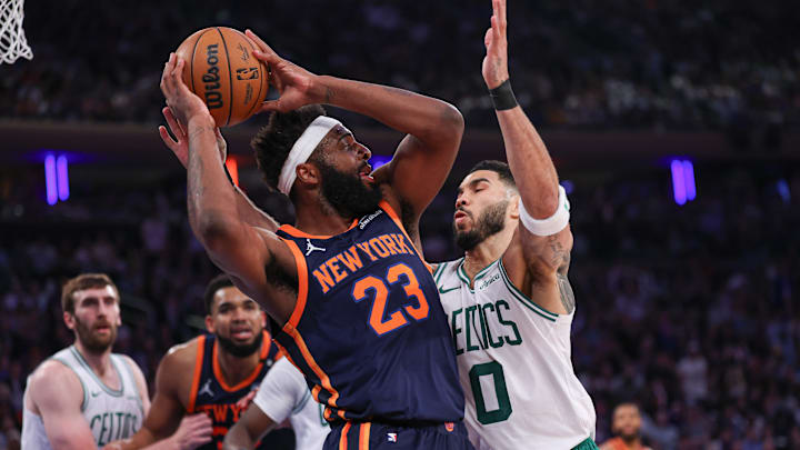 May 12, 2025; New York, New York, USA; New York Knicks center Mitchell Robinson (23) looks to pass after a rebound as Boston Celtics forward Jayson Tatum (0) defends in the first half during game four of the second round for the 2025 NBA Playoffs at Madison Square Garden. Mandatory Credit: Vincent Carchietta-Imagn Images