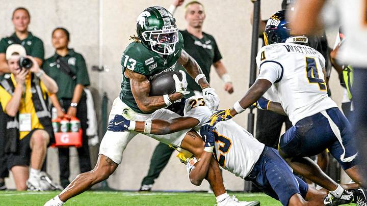 Michigan State’s Chrishon McCray, left, catches a pass as Toledo’s Israel Petite makes the tackle during the fourth quarter on Friday, Sept. 4, 2026, at Spartan Stadium in East Lansing.