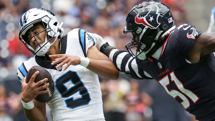Aug 16, 2025; Houston, Texas, USA; Carolina Panthers quarterback Bryce Young (9) is tackled for a loss by Houston Texans defensive end Will Anderson Jr. (51) in the first quarter at NRG Stadium.