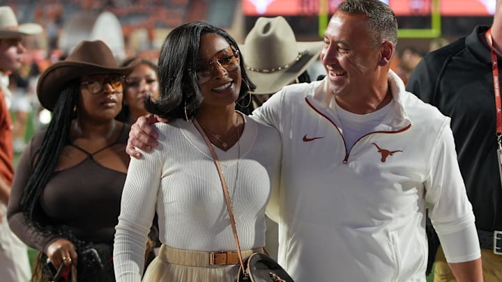 Texas Longhorns head coach Steve Sarkisian and his wife Loreal Sarkisian walk off the field after defeating the Kentucky Wildcats at Darrell K Royal Texas Memorial Stadium.
