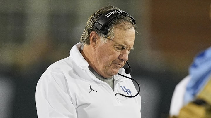 Sep 6, 2025; Charlotte, North Carolina, USA; North Carolina Tar Heels head coach Bill Belichic looks at his iPad during the second half against the Charlotte 49ers at Jerry Richardson Stadium. Mandatory Credit: Jim Dedmon-Imagn Images