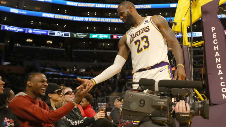 Nov 19, 2023; Los Angeles, California, USA;  Los Angeles Lakers forward LeBron James (23) shakes hands with his son Bronny James during the second half against the Houston Rockets at Crypto.com Arena. Mandatory Credit: Kiyoshi Mio-USA TODAY Sports