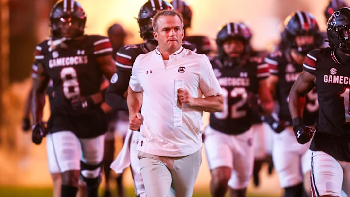 Sep 27, 2025; Columbia, South Carolina, USA; South Carolina Gamecocks head coach Shane Beamer leads his team onto the field during the Gamecocks 2001 entrance before their game against the Kentucky Wildcats at Williams-Brice Stadium. Mandatory Credit: Jeff Blake-Imagn Images