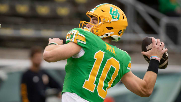 Oregon quarterback Bo Nix throws out a pass during warm ups as the No. 9 Oregon Ducks host