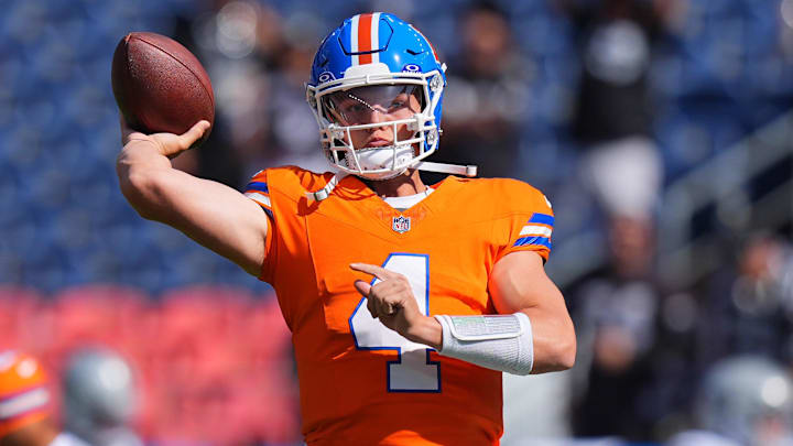 Denver Broncos quarterback Zach Wilson (4) warms up before the game against the Las Vegas Raiders at Empower Field at Mile High.