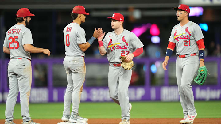 Aug 19, 2025; Miami, Florida, USA;  St. Louis Cardinals center fielder Nathan Church (27) celebrates a victory against the Miami Marlins with teammates at loanDepot Park. Mandatory Credit: Jim Rassol-Imagn Images