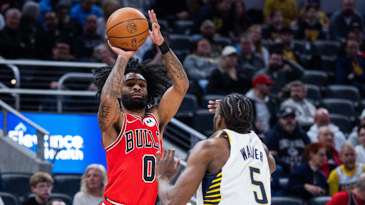 Jan 28, 2026; Indianapolis, Indiana, USA;  Chicago Bulls guard Coby White (0) shoots the ball while  Indiana Pacers forward Jarace Walker (5) defends in the first half at Gainbridge Fieldhouse. Mandatory Credit: Trevor Ruszkowski-Imagn Images