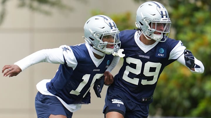 Dallas Cowboys cornerback Devin Moore (29) and safety Caleb Downs (18).