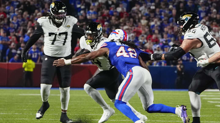 Sep 23, 2024; Orchard Park, New York, USA; Buffalo Bills linebacker Dorian Williams (42) tackles Jacksonville Jaguars running back Tank Bigsby (4) during the first half at Highmark Stadium.