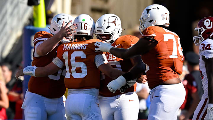 Texas Longhorns quarterback Arch Manning (16) celebrates with his lineman after he throws a touchdown against the Oklahoma Sooners during the second half at the Cotton Bowl. Texas Longhorns quarterback Arch Manning (16) celebrates with his lineman after he throws a touchdown against the Oklahoma Sooners during the second half at the Cotton Bowl.