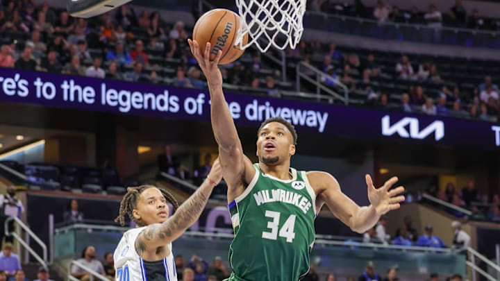 Dec 5, 2022; Orlando, Florida, USA; Milwaukee Bucks forward Giannis Antetokounmpo (34) goes to the basket against Orlando Magic guard Markelle Fultz (20) during the second half at Amway Center. Mandatory Credit: Mike Watters-Imagn Images