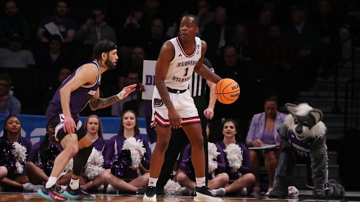 March 22, 2024, Brooklyn, NY, USA; Florida Atlantic Owls guard Johnell Davis (1) is defended by Northwestern Wildcats guard Boo Buie (0) in the first round of the 2024 NCAA Tournament at the Barclays Center. Mandatory Credit: Brad Penner-USA TODAY Sports