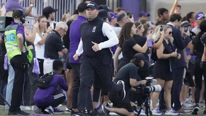 Sep 14, 2024; Evanston, Illinois, USA; Northwestern Wildcats head coach David Braun leads the team out against the Eastern Illinois Panthers  at Lanny and Sharon Martin Stadium. Mandatory Credit: David Banks-Imagn Images