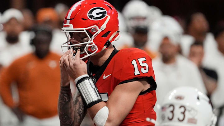 Georgia quarterback Carson Beck (15) putts in his mouth grad on the final play during overtime of the SEC championship game.
