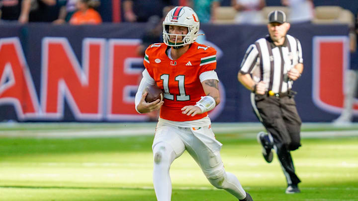 Nov 8, 2025; Miami Gardens, Florida, USA; Miami Hurricanes quarterback Carson Beck (11) rushes the ball against the Syracuse Orange during the first quarter at Hard Rock Stadium. Mandatory Credit: Jeff Romance-Imagn Images
