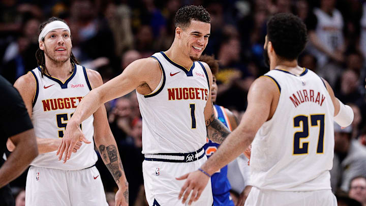 Mar 21, 2024; Denver, Colorado, USA: Denver Nuggets forward Michael Porter Jr. (1) reacts with guard Jamal Murray (27) ahead of forward Aaron Gordon (50) in the fourth quarter against the New York Knicks at Ball Arena. Mandatory Credit: Isaiah J. Downing-Imagn Images