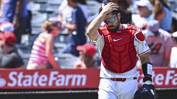 Aug 24, 2025; Anaheim, California, USA; Los Angeles Angels catcher Travis d'Arnaud (25) drops his mask and helmet against the Chicago Cubs during the fifth inning at Angel Stadium. Mandatory Credit: Jonathan Hui-Imagn Images