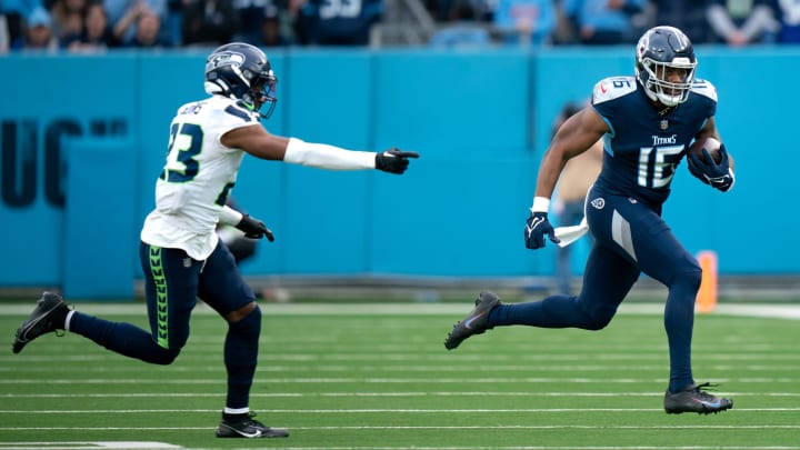 Tennessee Titans wide receiver Treylon Burks (16) runs after the catch as Seattle Seahawks safety Jamal Adams (33) pursues late in the fourth quarter of their game at Nissan Stadium. Tennessee Titans wide receiver Treylon Burks (16) runs after the catch as Seattle Seahawks safety Jamal Adams (33) pursues late in the fourth quarter of their game at Nissan Stadium.