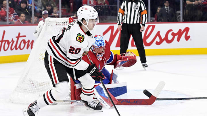 Dec 18, 2025; Montreal, Quebec, CAN; Chicago Blackhawks forward Ryan Greene (20) plays the puck next to Montreal Canadiens goalie Jakub Dobes (75) during the second period at the Bell Centre. Mandatory Credit: Eric Bolte-Imagn Images
