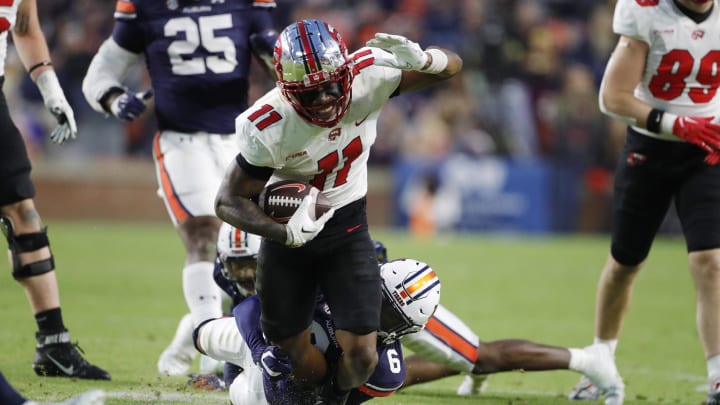 Nov 19, 2022; Auburn, Alabama, USA; Western Kentucky Hilltoppers wide receiver Malachi Corley (11) dives for yardage as Auburn Tigers cornerback Keionte Scott (6) grabs his ankles during the second quarter at Jordan-Hare Stadium. Nov 19, 2022; Auburn, Alabama, USA; Western Kentucky Hilltoppers wide receiver Malachi Corley (11) dives for yardage as Auburn Tigers cornerback Keionte Scott (6) grabs his ankles during the second quarter at Jordan-Hare Stadium.