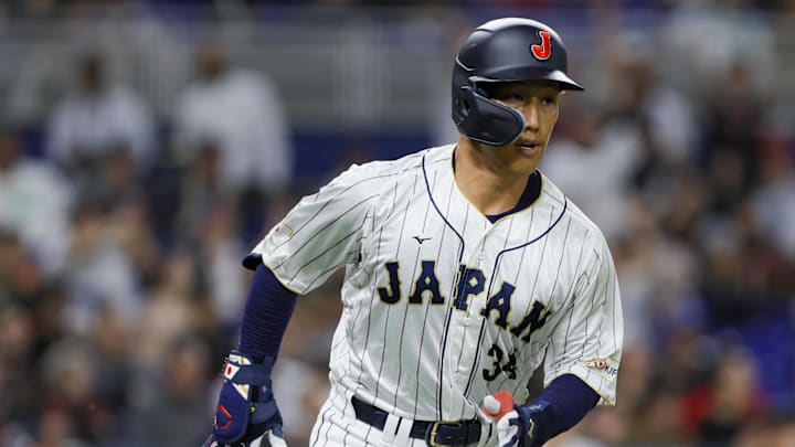 Mar 20, 2023; Miami, Florida, USA; Japan left fielder Masataka Yoshida (34) runs toward first base after a base hit during the second inning against Mexico at LoanDepot Park. Mandatory Credit: Sam Navarro-Imagn Images