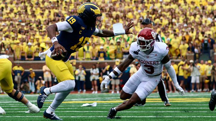 Oklahoma defensive back Reggie Powers III pursues Michigan quarterback Bryce Underwood in the first half at The Big House.