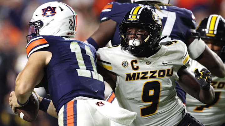 Oct 18, 2025; Auburn, Alabama, USA;  Missouri Tigers defensive end Zion Young (9) moves in to tackle Auburn Tigers quarterback Jackson Arnold (11) during the fourth quarter at Jordan-Hare Stadium.  Mandatory Credit: John Reed-Imagn Images