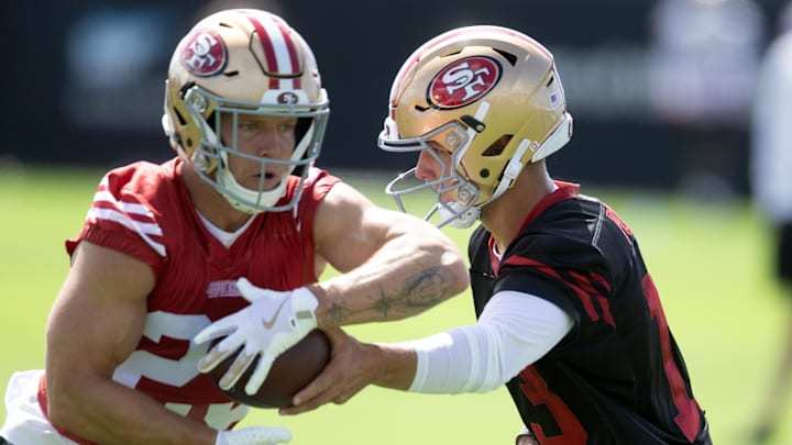 Jul 23, 2025; Santa Clara, CA, USA; San Francisco 49ers quarterback Brock Purdy (13) hands off to running back Christian McCaffrey (23) during the first day of training camp at SAP Performance Facility. Mandatory Credit: D. Ross Cameron-Imagn Images